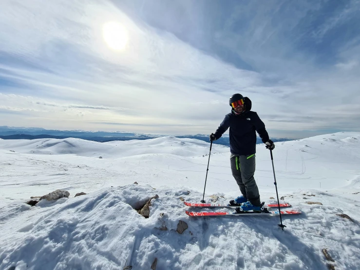 a person riding skis on top of a snowy slope