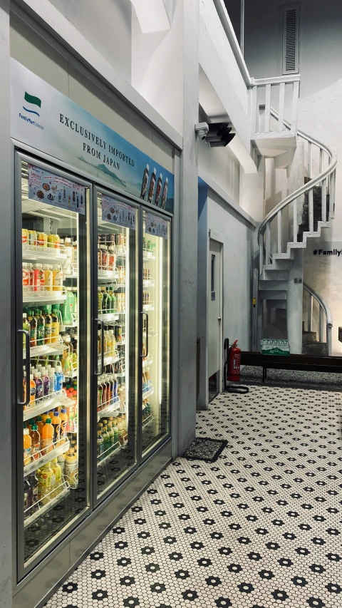 there are many different beverage coolers next to the staircase