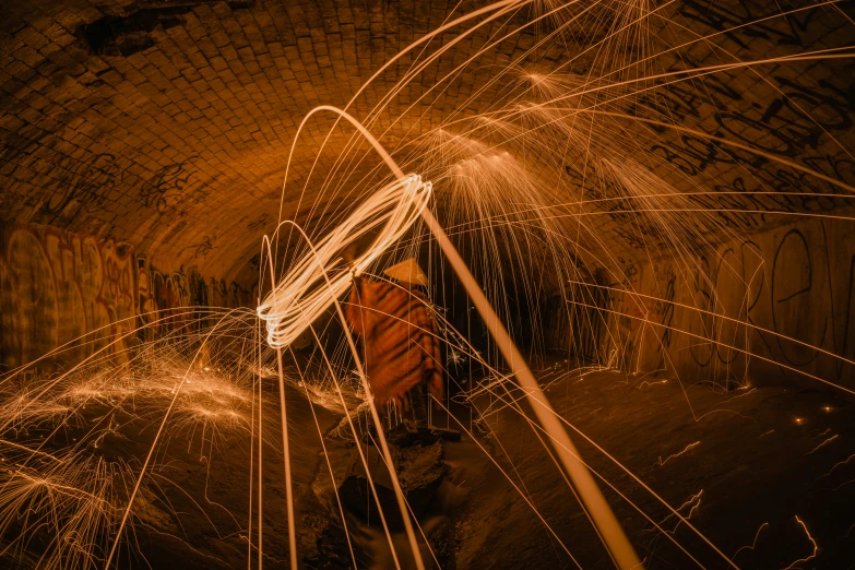fireworks are lit in a tunnel by a man
