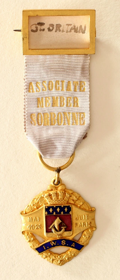 two medals attached to each other against a white surface