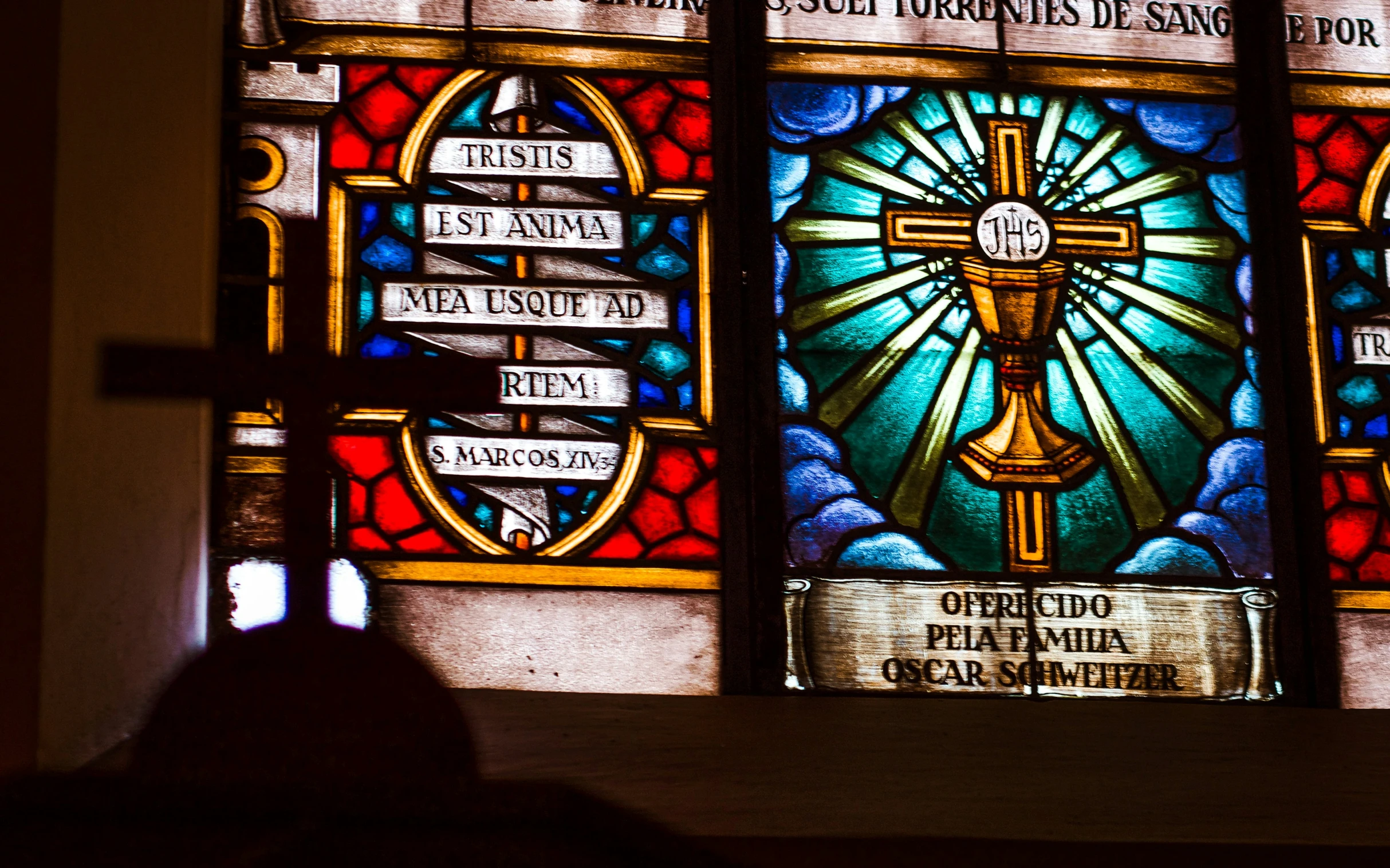 a church window with religious writing on it