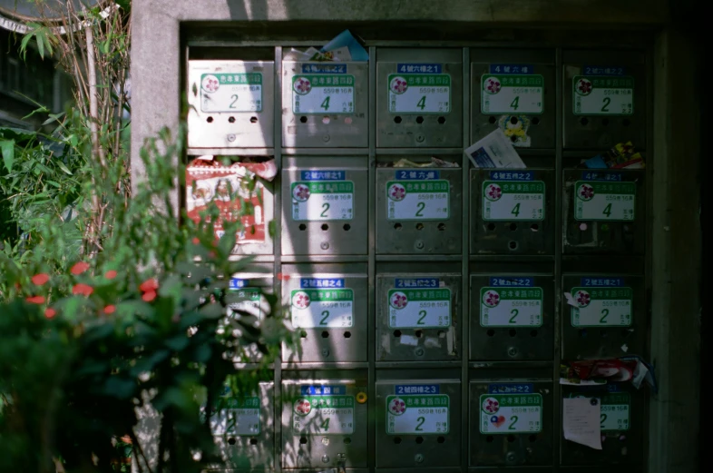 a bunch of mailboxs are displayed on the side of a building