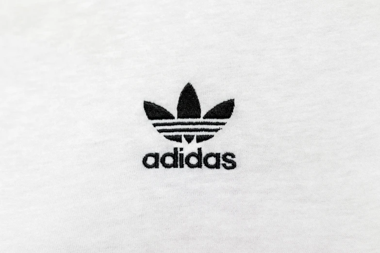 a white adidas tee shirt with the adidas logo on it