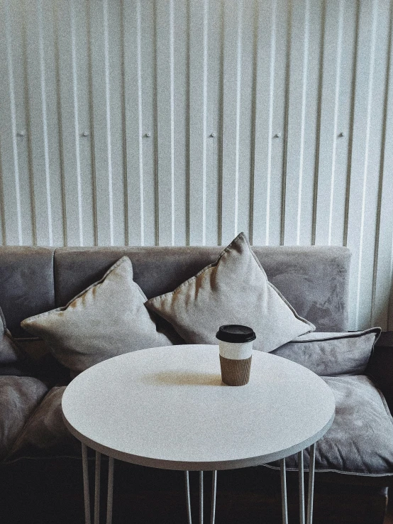 a coffee cup is sitting on a white table