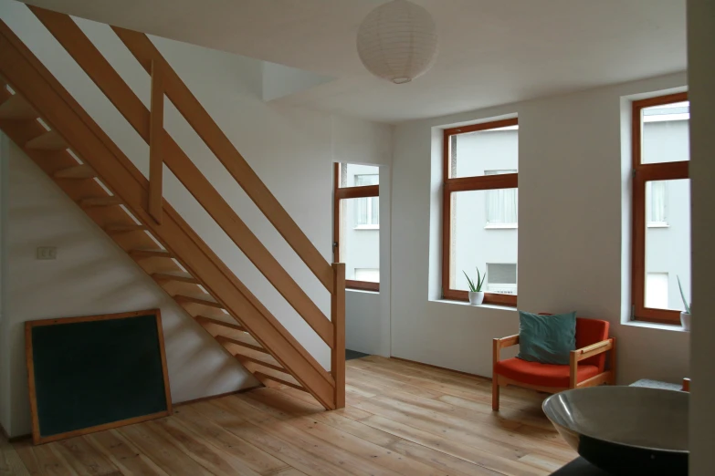 the room has wooden floors and white walls