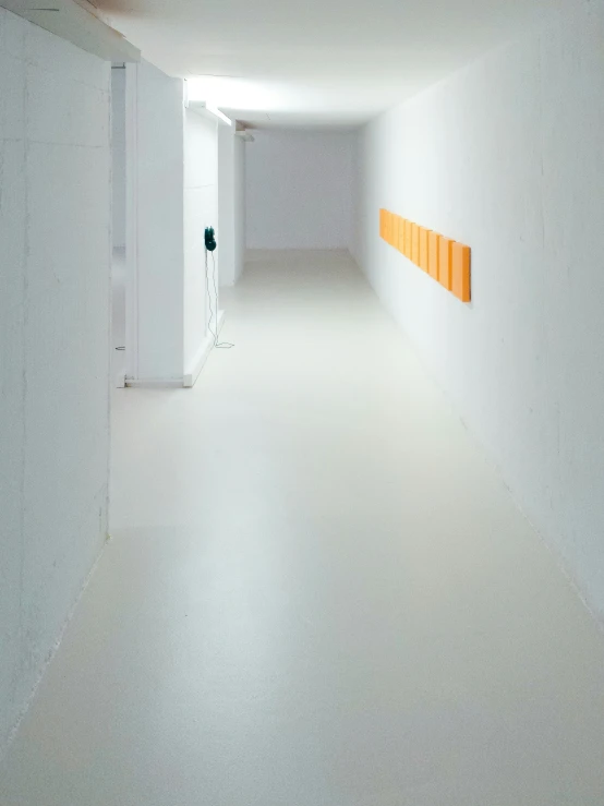 an empty room with yellow file cabinets and a wall in the middle