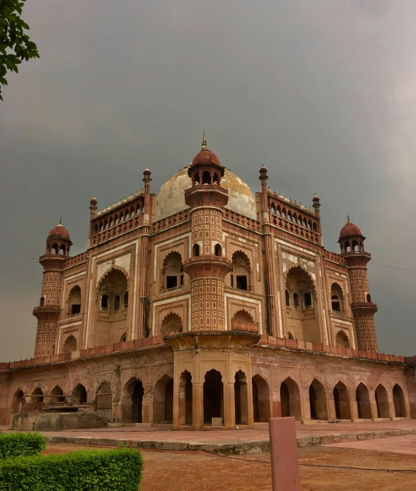 a building has several pillars and arches and arches with a turret