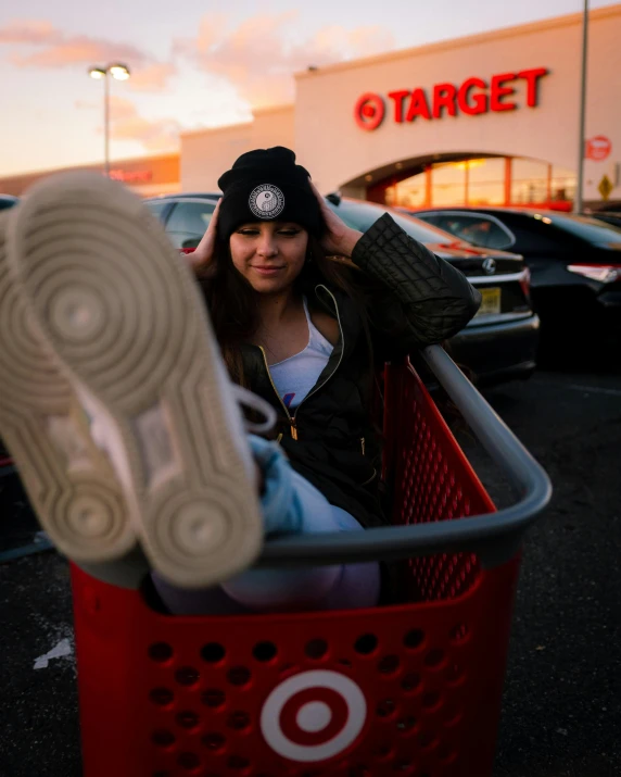 a woman has her head up and is in a shopping cart outside a target store