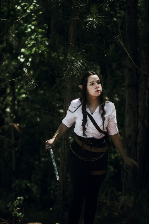 a woman with a sword in the woods