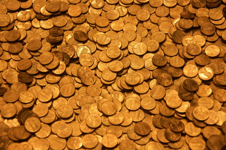 a pile of golden coins sitting on top of a table