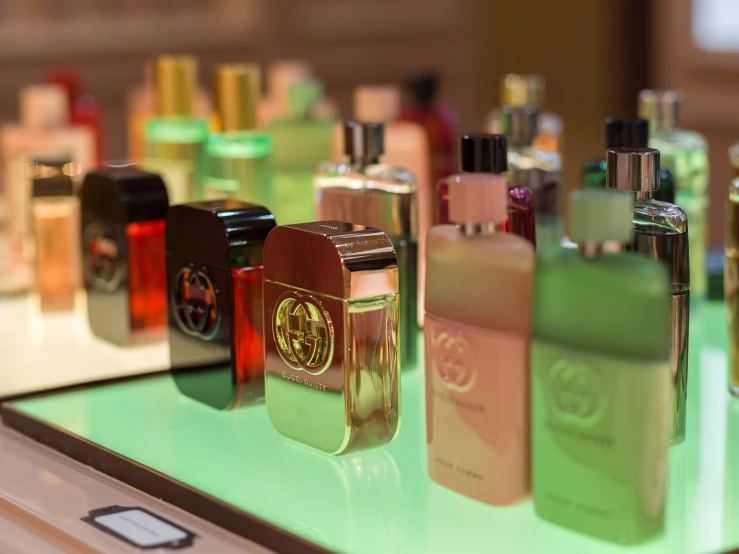 a variety of perfume bottles sitting on top of a counter