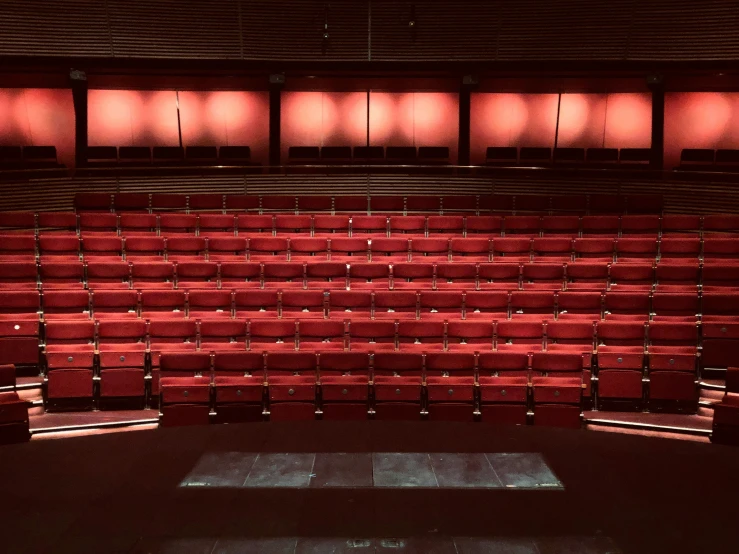 a stage that looks like an auditorium filled with red seats