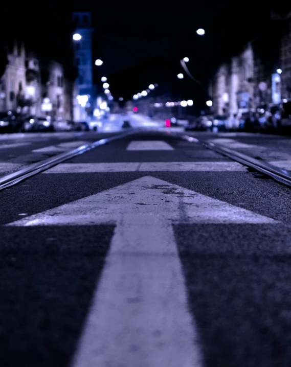 a empty road with a white arrow painted on it