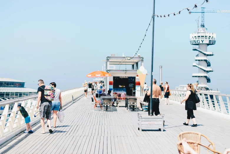 some people on the boardwalk of a cruise ship