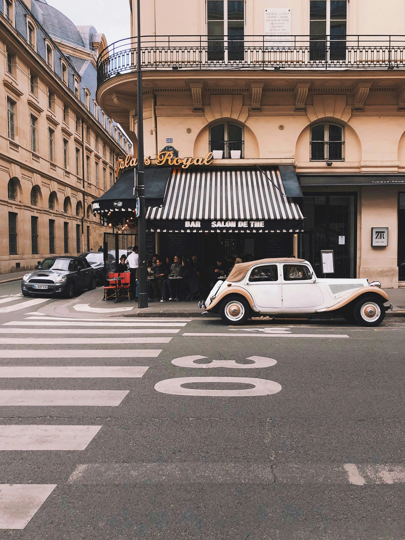 an old car is parked on the side of the road