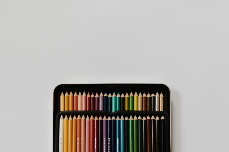 colorful pencils in a container, sitting on the wall