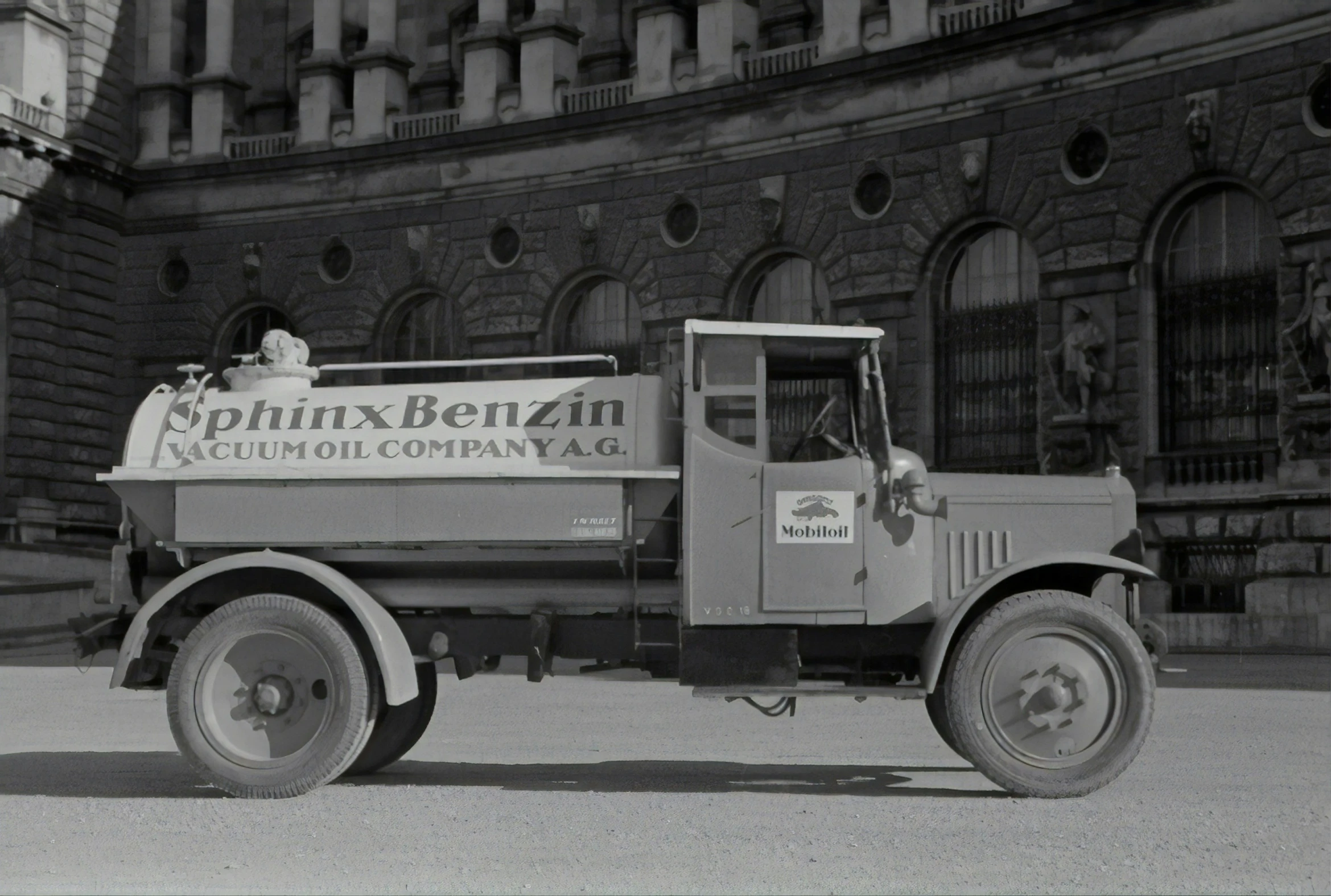 an old truck that is sitting outside of a building