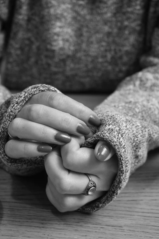 black and white image of a woman holding her hands together