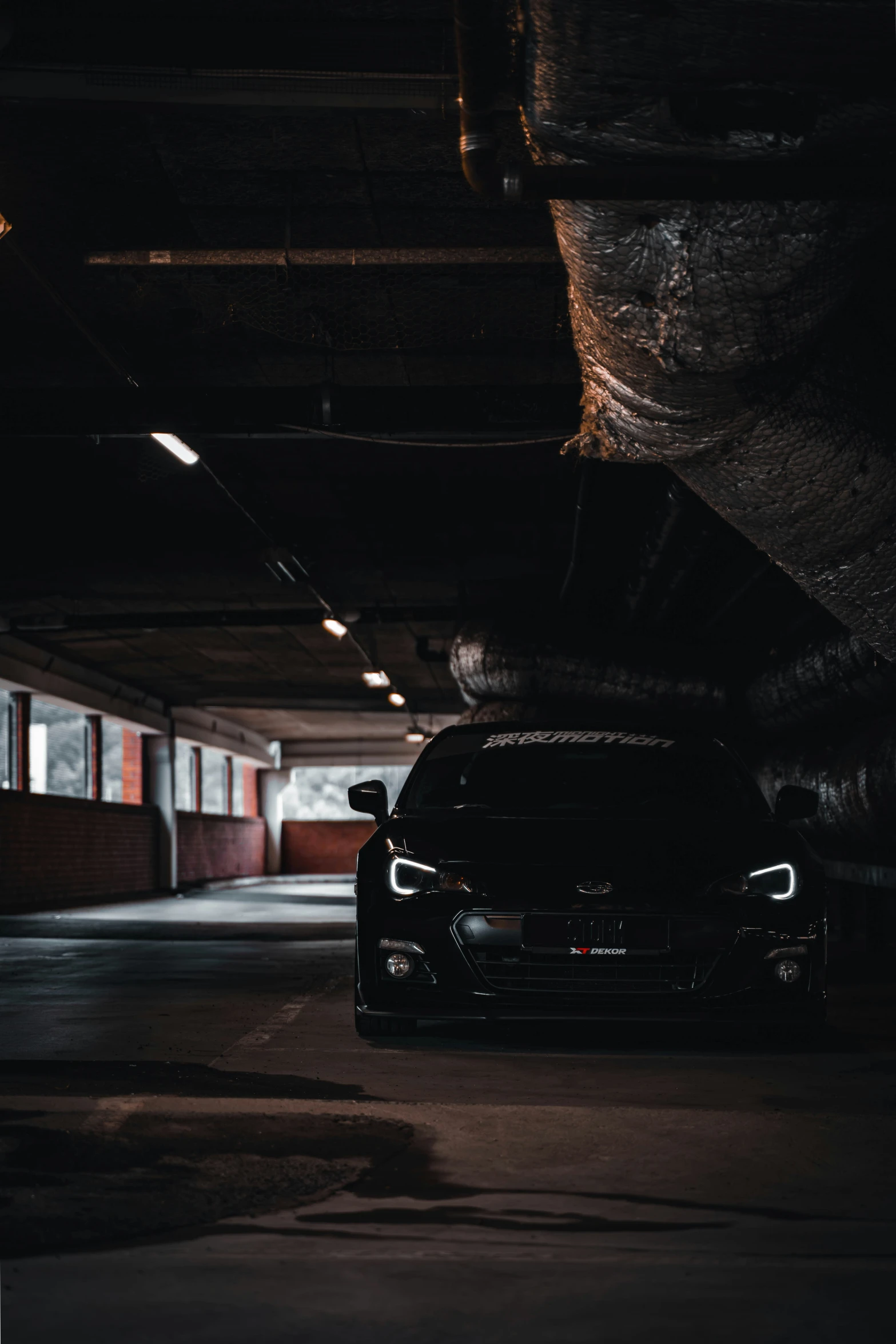 the front end of a vehicle in a parking garage