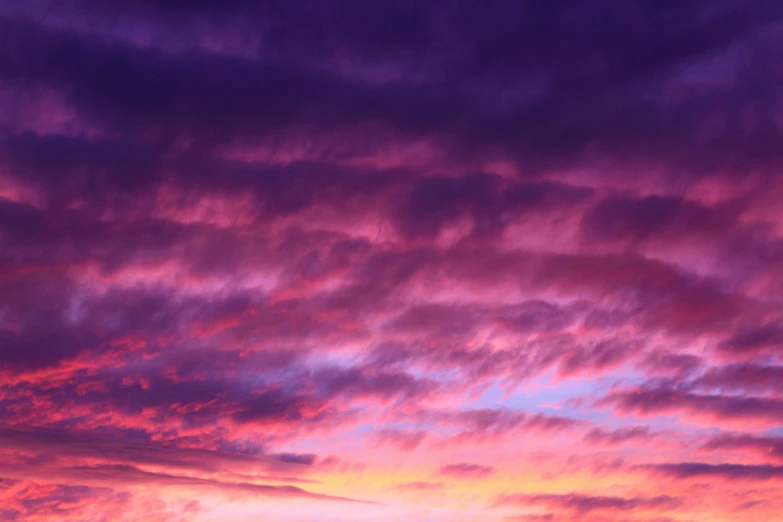 the sky is lit up with an orange and purple sunset