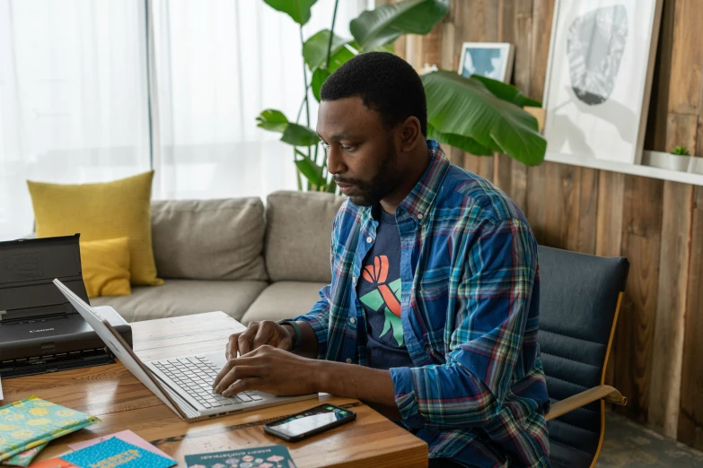 a man sitting in front of a laptop computer