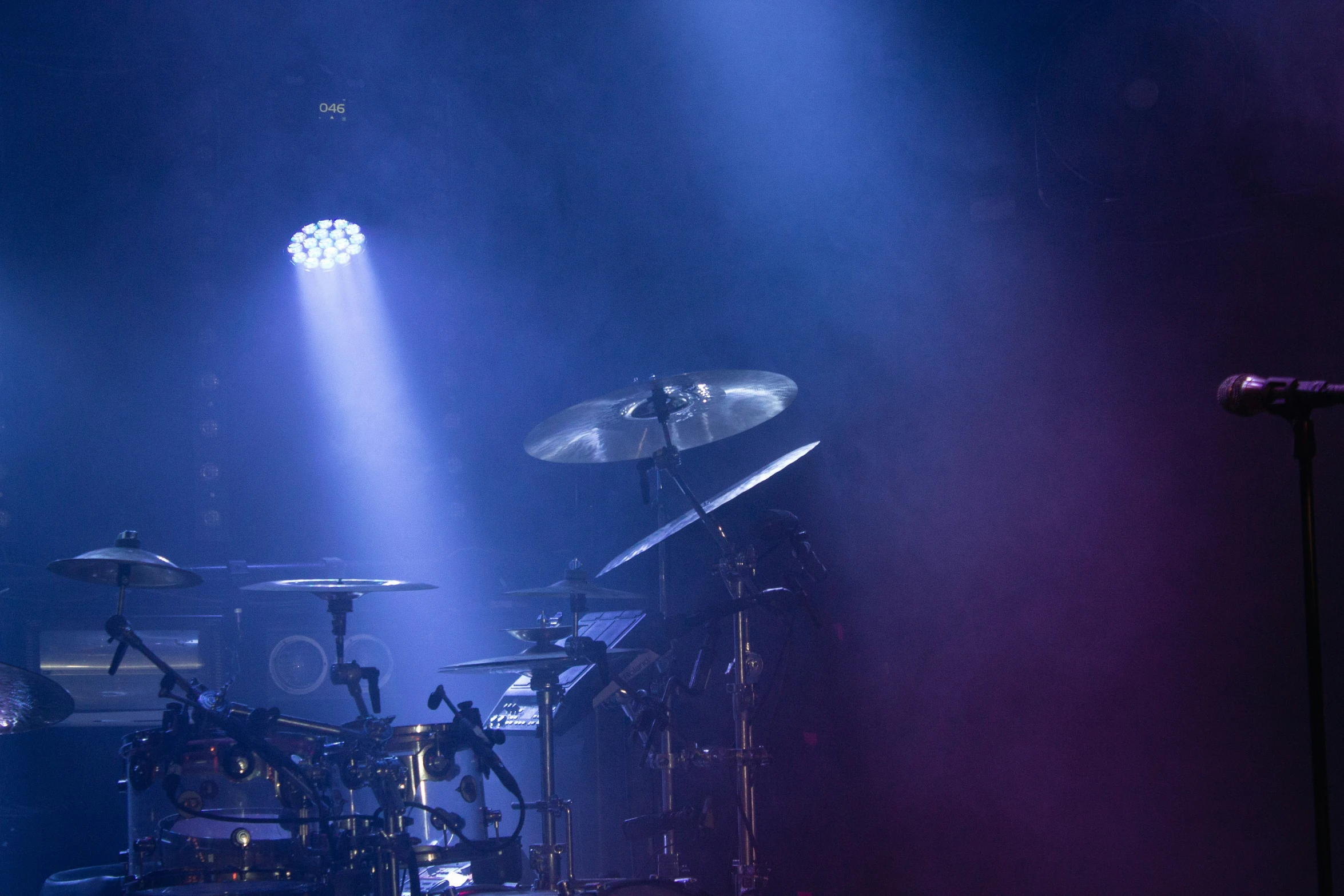 a music band performs on stage on a darkened background