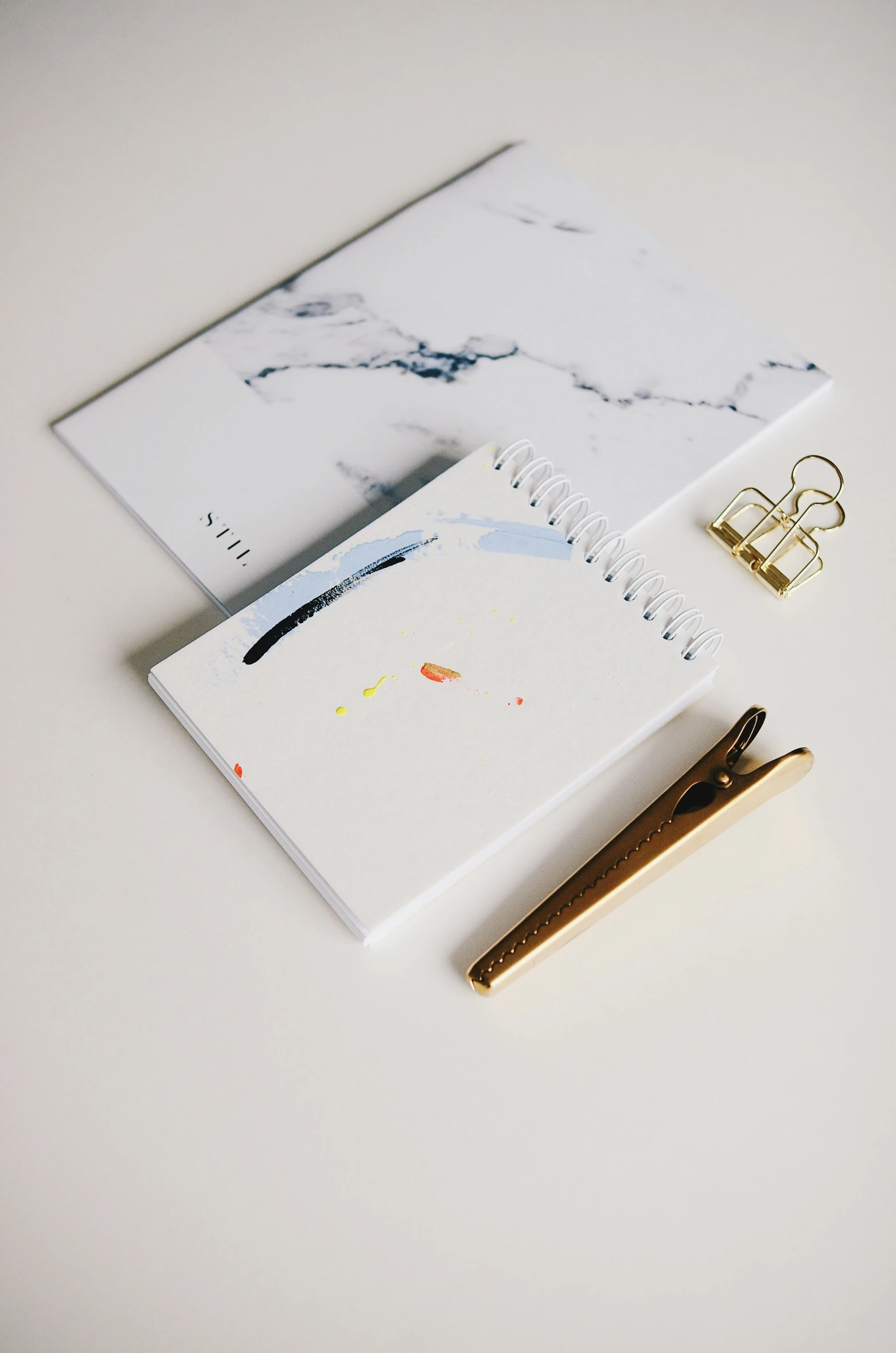 a notepad next to a pen on top of a table