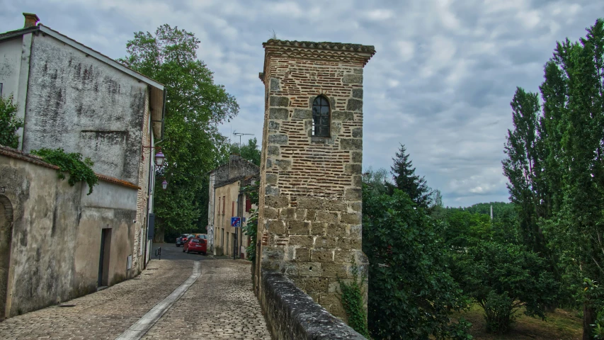 a brick tower rises above another brick tower