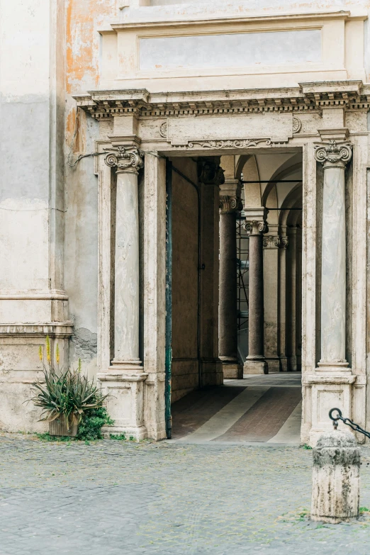 a white building with a stone structure and stairs