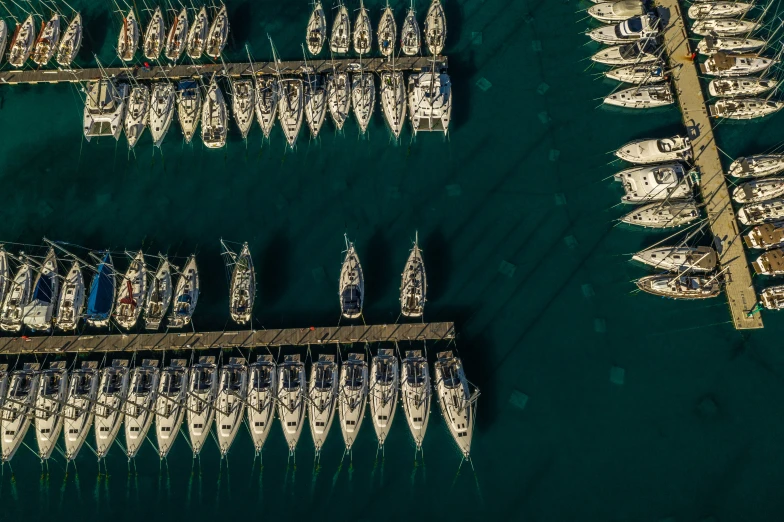 several boats in a row and one is moored at the dock