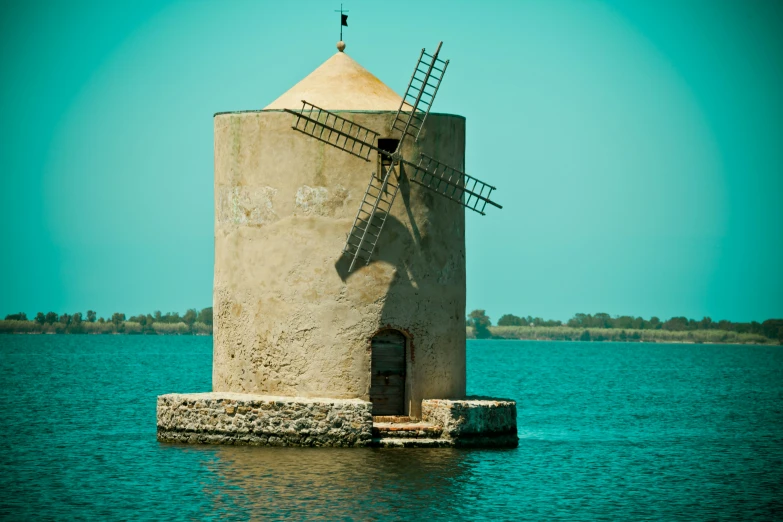 an old tower structure in the middle of a lake