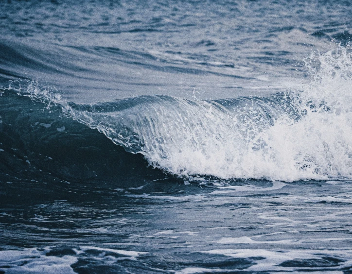 an image of a wave crashing with the water crashing