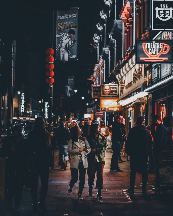 people walking on the sidewalk in an asian city