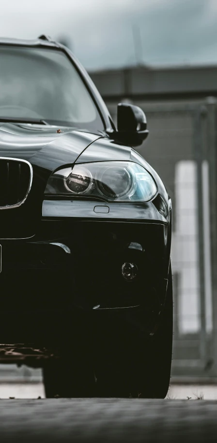 a black car that is sitting in the dirt