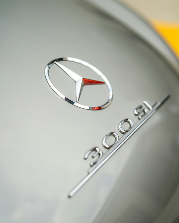 the emblem of a luxury car with a yellow emblem behind it