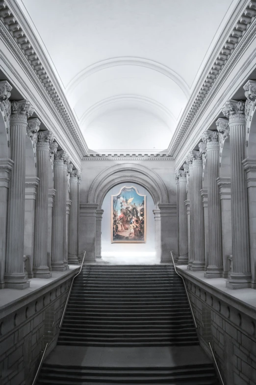 an art museum hallway with staircases leading to paintings