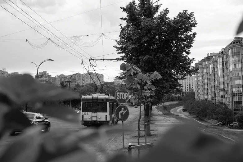 a bus driving on the road next to a tall building