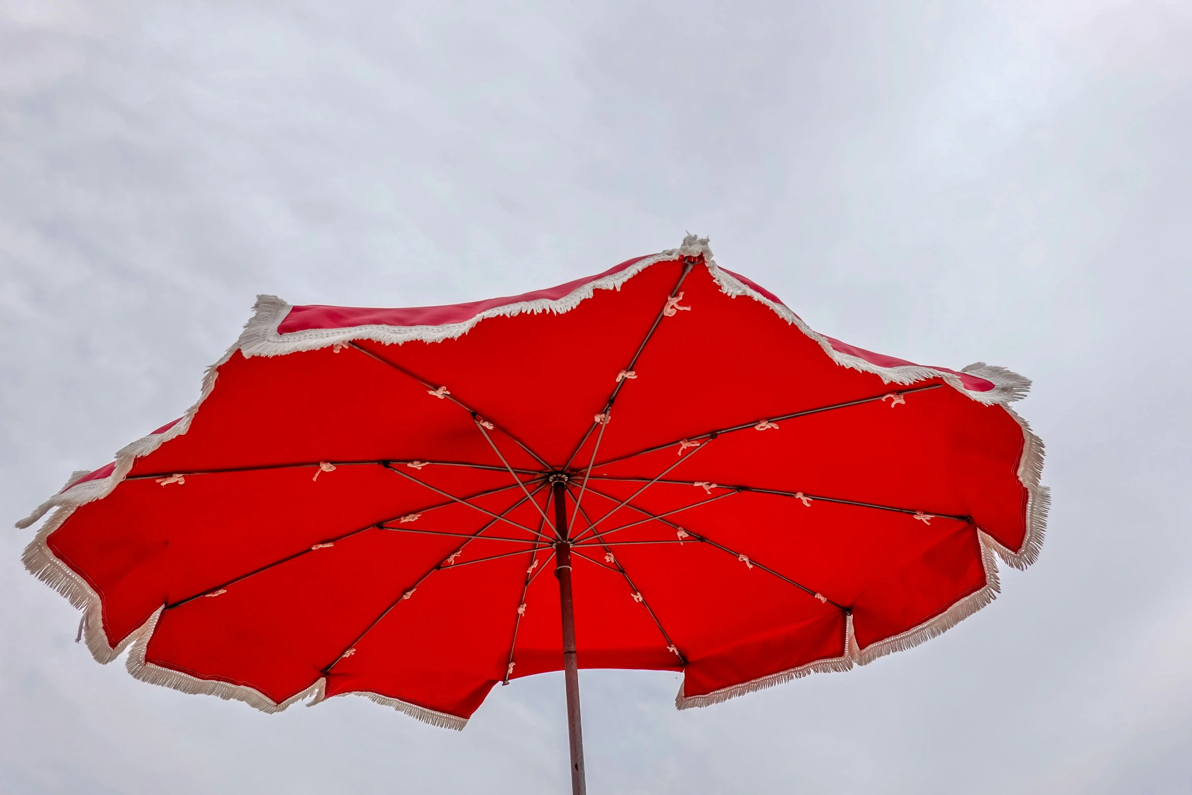 a red umbrella with some string lights hanging from it