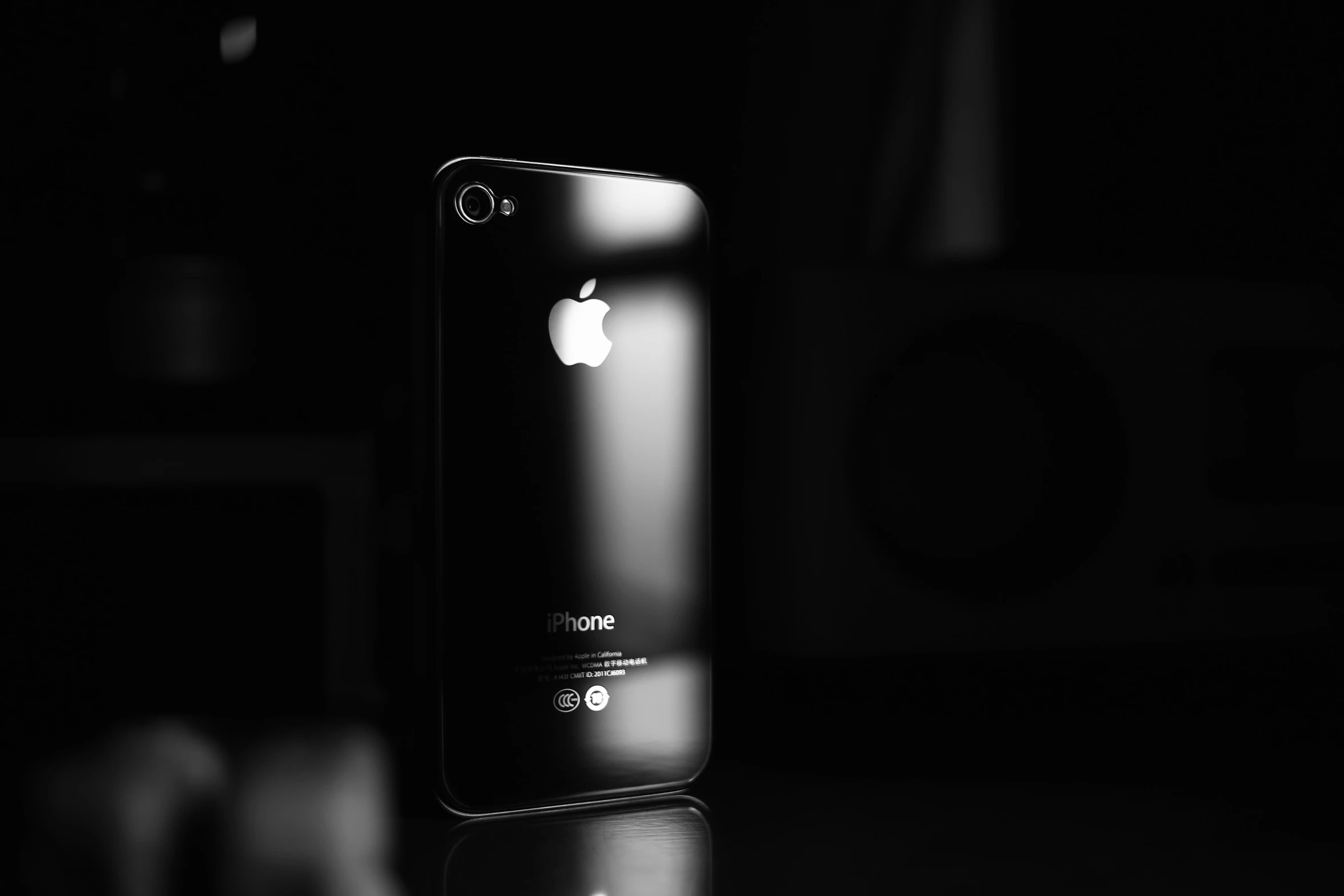 an iphone is pographed in a dim lit room