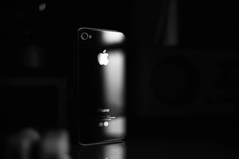 an iphone is pographed in a dim lit room