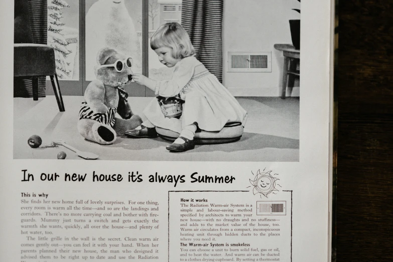 a newspaper page with a baby playing with a teddy bear