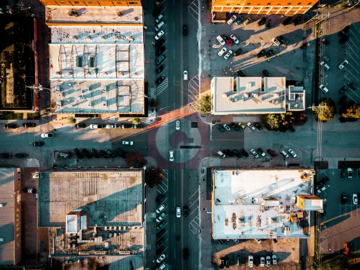 an aerial view of a parking lot with tables and umbrellas