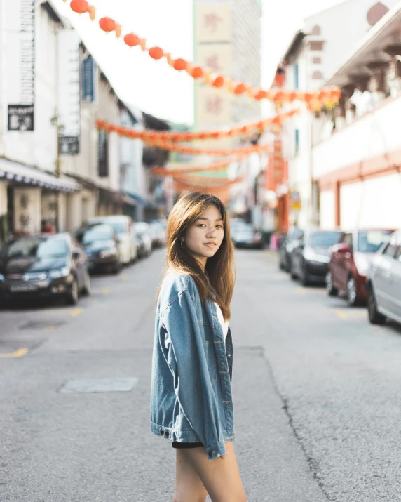 young woman posing at an asian street corner