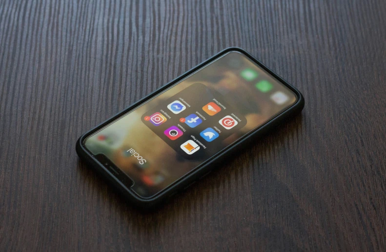 a close up of an iphone sitting on a table