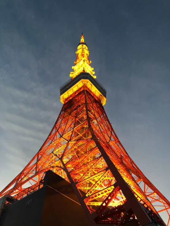 a tall tower with lights lit up at the bottom