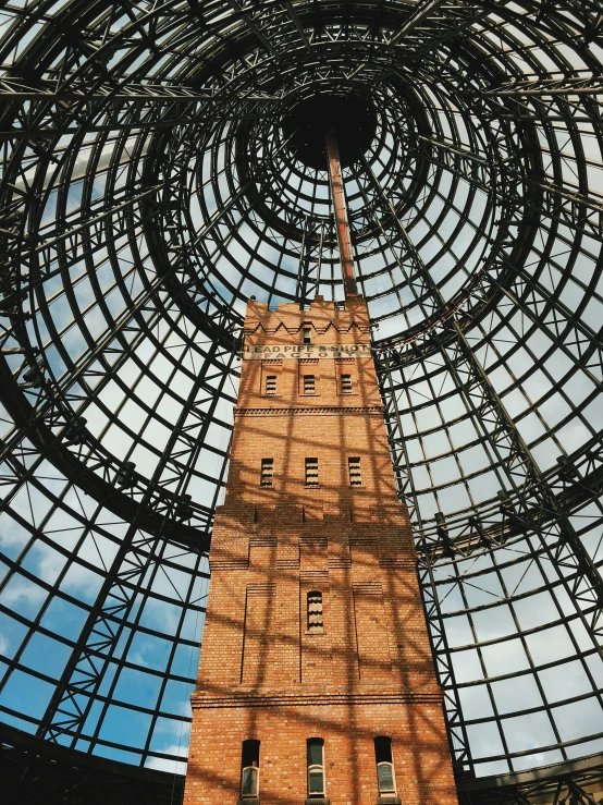 an inside view of a tall tower with glass walls