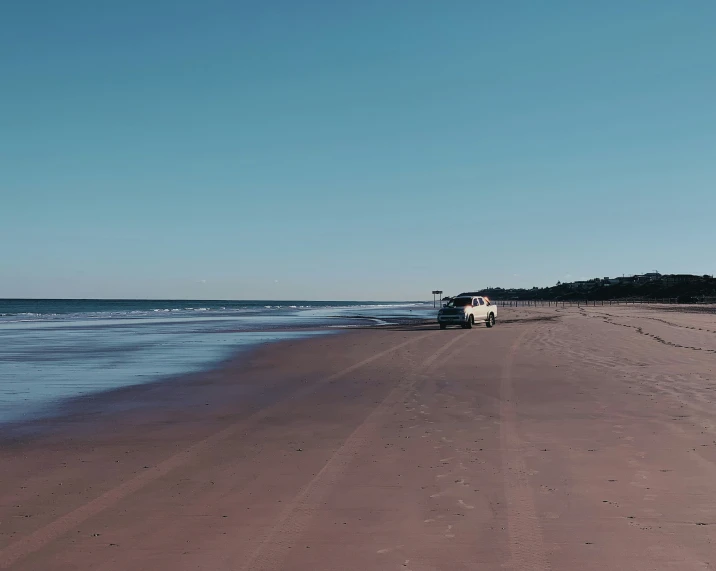 there is a truck parked on the beach