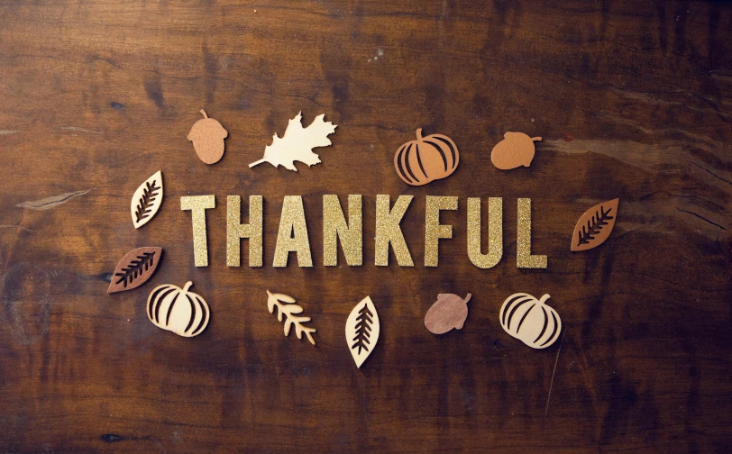 the word thanksgiving spelled out with cutouts of leaves