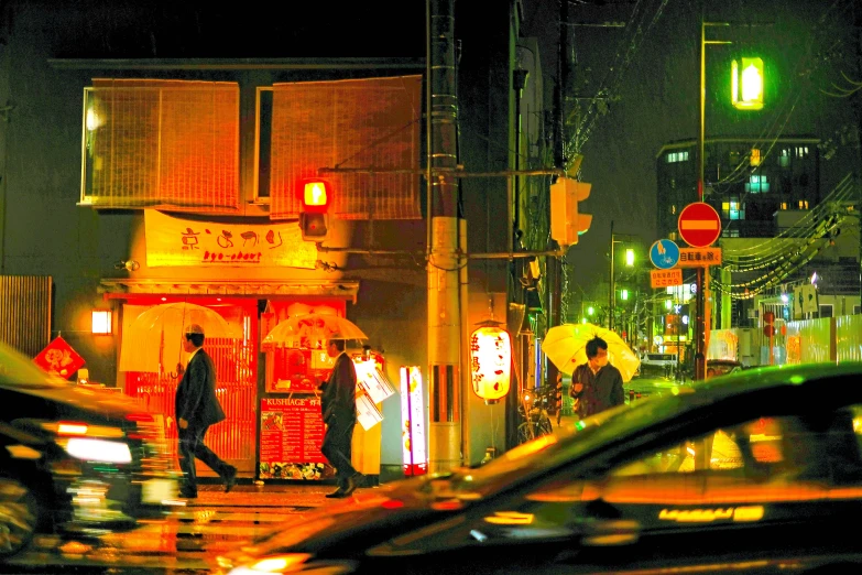 some cars driving down the road in front of a store