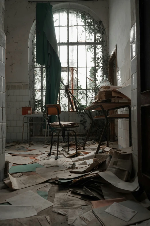 an old room with a table and chairs with lots of papers everywhere